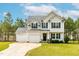 Charming two-story home with a manicured lawn and a two-car garage, perfect for Gathering living at 5989 Zacks Mill Rd, Angier, NC 27501