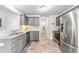 Modern kitchen with gray cabinets, stainless steel appliances, and granite countertops, ready for cooking at 5989 Zacks Mill Rd, Angier, NC 27501
