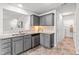 Well-lit kitchen featuring stainless steel appliances and gray cabinets with granite countertops at 5989 Zacks Mill Rd, Angier, NC 27501