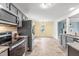 Open-concept kitchen with stainless steel appliances, connecting seamlessly to the dining and living areas at 5989 Zacks Mill Rd, Angier, NC 27501
