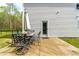 Enjoy outdoor living on the spacious patio, furnished with a dining set and umbrella at 5989 Zacks Mill Rd, Angier, NC 27501