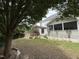 Spacious backyard featuring a brick pizza oven and a cozy pergola-covered area beside the screened-in back porch at 6020 Jones Farm Rd, Wake Forest, NC 27587
