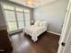 Cozy bedroom with hardwood floors, a large window, and neutral decor at 6020 Jones Farm Rd, Wake Forest, NC 27587