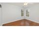 Bright bedroom with hardwood floors, two windows, and a ceiling fan at 6020 Jones Farm Rd, Wake Forest, NC 27587