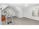 Spacious bonus room featuring gray carpet, ceiling fan, and natural light at 6020 Jones Farm Rd, Wake Forest, NC 27587
