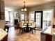 Cozy dining area with a glass table, view of the fireplace, and access to the screened porch at 6020 Jones Farm Rd, Wake Forest, NC 27587