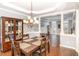 Elegant dining room with hardwood floors, a display cabinet and a large chandelier at 6020 Jones Farm Rd, Wake Forest, NC 27587