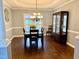 Formal dining room with a decorative chandelier, dark wood table, and elegant furnishings at 6020 Jones Farm Rd, Wake Forest, NC 27587