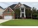 Beautiful red brick home with manicured lawn, attached two car garage and stylish front entrance at 6020 Jones Farm Rd, Wake Forest, NC 27587