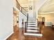 Spacious foyer with hardwood floors, staircase with decorative iron railing, and open view to other rooms at 6020 Jones Farm Rd, Wake Forest, NC 27587