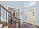 Bright foyer featuring a front door and a staircase with wood and wrought iron railings at 6020 Jones Farm Rd, Wake Forest, NC 27587