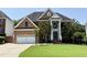 Beautiful brick home with a well-manicured lawn, attached garage, and grand entrance with columns at 6020 Jones Farm Rd, Wake Forest, NC 27587