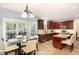 Bright eat-in kitchen features granite countertops, cherry cabinets, and stainless steel appliances at 6020 Jones Farm Rd, Wake Forest, NC 27587