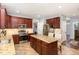 Well-appointed kitchen features cherry cabinets, granite countertops, and a center island with seating at 6020 Jones Farm Rd, Wake Forest, NC 27587