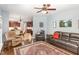 Spacious living room with leather furniture open to kitchen area, features a ceiling fan at 6020 Jones Farm Rd, Wake Forest, NC 27587