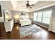 Charming main bedroom featuring a tray ceiling, a ceiling fan, a window array, and hardwood floors at 6020 Jones Farm Rd, Wake Forest, NC 27587