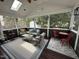Screened-in sun room with comfortable seating, ceiling fan and skylight offering an inviting relaxation space at 6020 Jones Farm Rd, Wake Forest, NC 27587