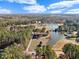 Aerial view showcasing a charming home, pond, lush greenery and serene community at 615 Woodland Trl, Louisburg, NC 27549