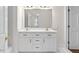 Bathroom featuring a double vanity, white cabinets, and bronze hardware, offering plenty of storage at 615 Woodland Trl, Louisburg, NC 27549