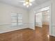 Open dining room with hardwood floors, view to another room, and nice lighting at 615 Woodland Trl, Louisburg, NC 27549