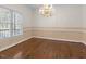 Formal dining room with hardwood floors, a chandelier, and stylish wallpaper at 615 Woodland Trl, Louisburg, NC 27549