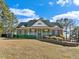 Charming brick home with a well-maintained lawn and manicured landscaping features at 615 Woodland Trl, Louisburg, NC 27549