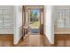 Inviting foyer with beautiful hardwood floors and an elegant front door with glass panels at 615 Woodland Trl, Louisburg, NC 27549