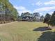 Charming home with a well-maintained front yard, complemented by mature trees and professional landscaping at 615 Woodland Trl, Louisburg, NC 27549