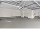 Spacious two car garage with ample space and multiple entry doors at 615 Woodland Trl, Louisburg, NC 27549