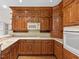 Classic kitchen design with wooden cabinets, white countertops, and modern appliances at 615 Woodland Trl, Louisburg, NC 27549