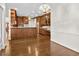 Kitchen and breakfast nook featuring wood cabinets, a long breakfast bar, and hardwood floors at 615 Woodland Trl, Louisburg, NC 27549