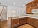 Open kitchen design with an island, stainless steel dishwasher, and a view of the staircase at 615 Woodland Trl, Louisburg, NC 27549