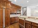 Kitchen with breakfast nook featuring wood cabinets, modern countertops, and a stainless steel dishwasher at 615 Woodland Trl, Louisburg, NC 27549