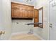 Functional laundry area with custom cabinets and space-saving ironing board at 615 Woodland Trl, Louisburg, NC 27549