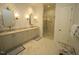 Elegant bathroom with double vanity, marble countertop, and glass-enclosed shower at 620 Wade Ave # 206, Raleigh, NC 27605