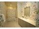 Charming bathroom featuring floral wallpaper and a gray vanity with a mirror at 620 Wade Ave # 206, Raleigh, NC 27605