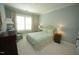 Cozy bedroom with a green patterned bedspread and matching chair at 620 Wade Ave # 206, Raleigh, NC 27605
