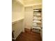 Walk-in closet with custom shelving and hardwood floors at 620 Wade Ave # 206, Raleigh, NC 27605