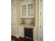 Dry bar featuring granite countertop, wine cooler, and glass front upper cabinets at 620 Wade Ave # 206, Raleigh, NC 27605