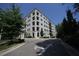View of building with black framed windows and balconies, and well maintained sidewalk at 620 Wade Ave # 206, Raleigh, NC 27605