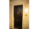 Elegant suite entrance featuring a black door with brass accents and sconce lighting at 620 Wade Ave # 206, Raleigh, NC 27605