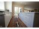 Kitchen island featuring sleek white cabinetry, granite countertops, and stainless steel appliances at 620 Wade Ave # 206, Raleigh, NC 27605