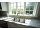 Kitchen sink area featuring granite countertops, tiled backsplash, and stainless steel appliances at 620 Wade Ave # 206, Raleigh, NC 27605