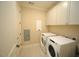 Bright laundry room with white cabinets and modern washer and dryer at 620 Wade Ave # 206, Raleigh, NC 27605