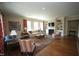 Spacious living room featuring hardwood floors, fireplace, built-in shelving, and large windows at 620 Wade Ave # 206, Raleigh, NC 27605
