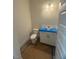Modern half bathroom with a white vanity, toilet, and stylish light fixture, offering a clean and functional space at 70 Valebrook Ct, Youngsville, NC 27596