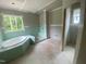 Bathroom featuring a soaking tub, drywall and a window at 70 Valebrook Ct, Youngsville, NC 27596