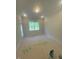 Bright bedroom with a large window and ample natural light, creating a serene and inviting atmosphere at 70 Valebrook Ct, Youngsville, NC 27596