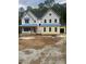 Two-story home with a dark roof, light siding, and visible construction materials in the yard at 70 Valebrook Ct, Youngsville, NC 27596