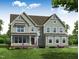 Charming two-story home with gray siding, a covered porch, and a well-maintained lawn at 70 Valebrook Ct, Youngsville, NC 27596